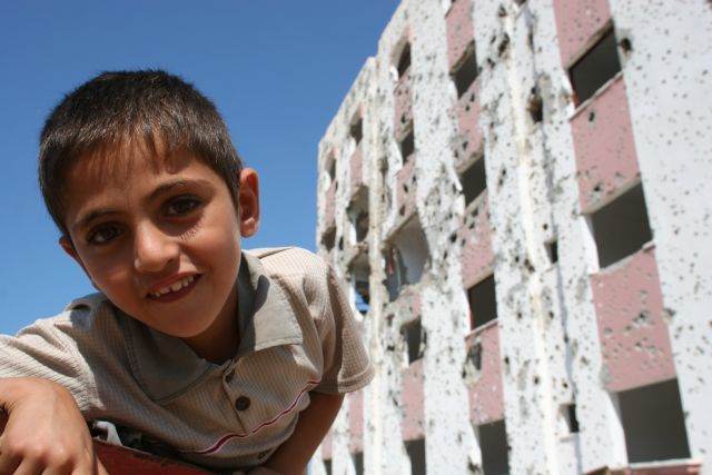Boy in front of a shelled building — Jenin