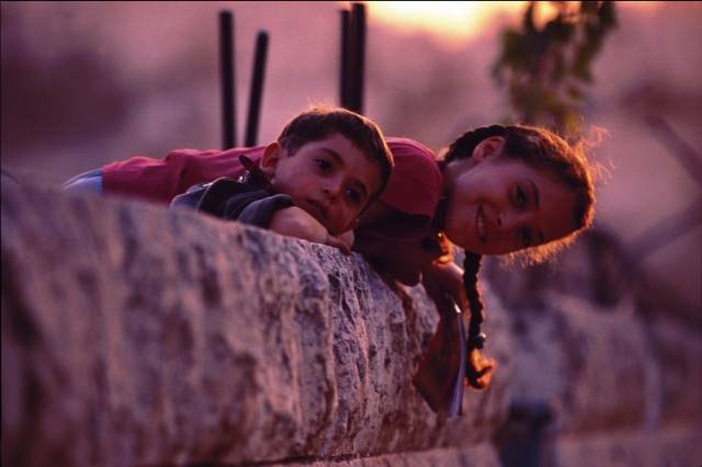 Kids on the rubble at sunset